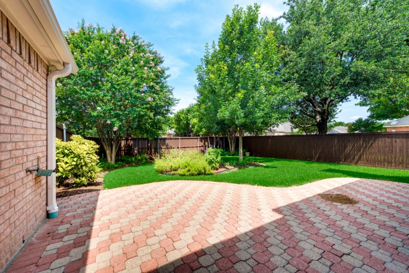    Extended Paver Patio leads to Beautifully Landscaped Backyard 