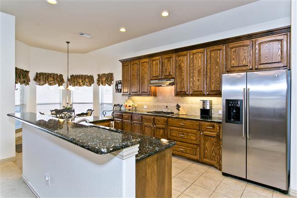    Wood Grain Cabinets and Stainless Steel Appliance 