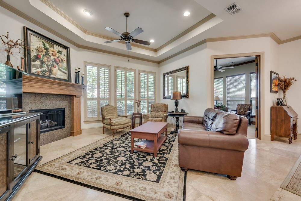    Inviting Family Room with Tray Ceiling Crown Molding Plantation Shutters 