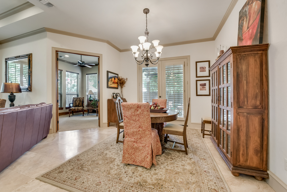    Dining has Crown Molding Plantation Shutters and Door to Patio 
