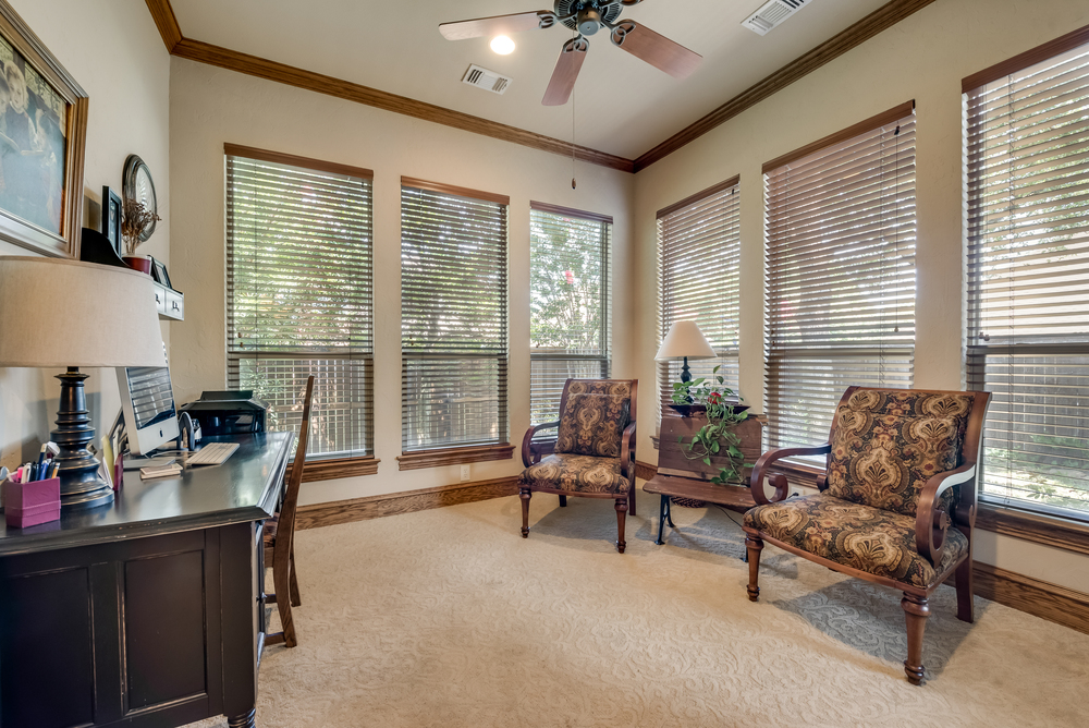    Study is cozy with Glass French Doors Crown Molding and Abundance of Natural Light 