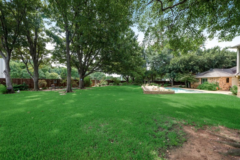    Large Grassy Play Yard Sparkling Swimming Pool Wood Deck and Gardens 