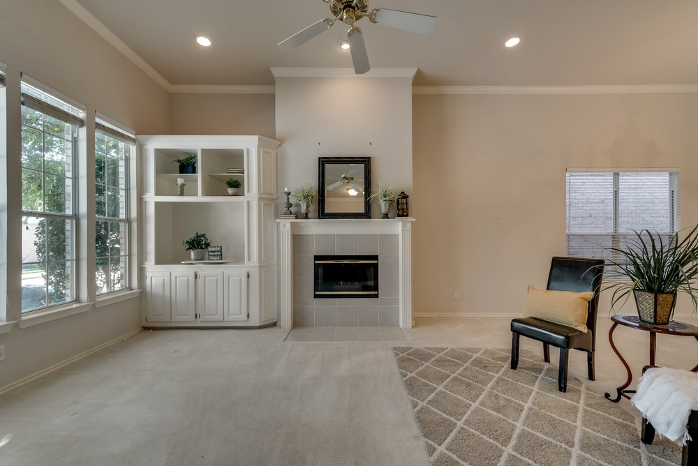    Family Room with Wall of Windows Gas Log Fireplace and White Built In Cabinetry for Entertainment Storage 