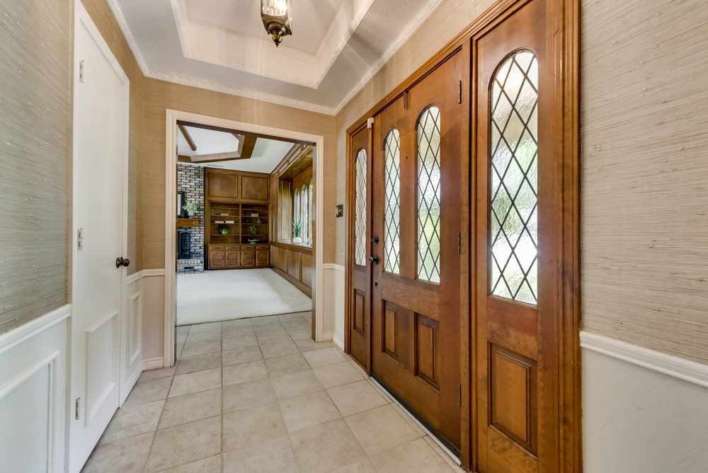    Entry with Lead Glass Inlaid Front Door with Wrought Iron Detailing 