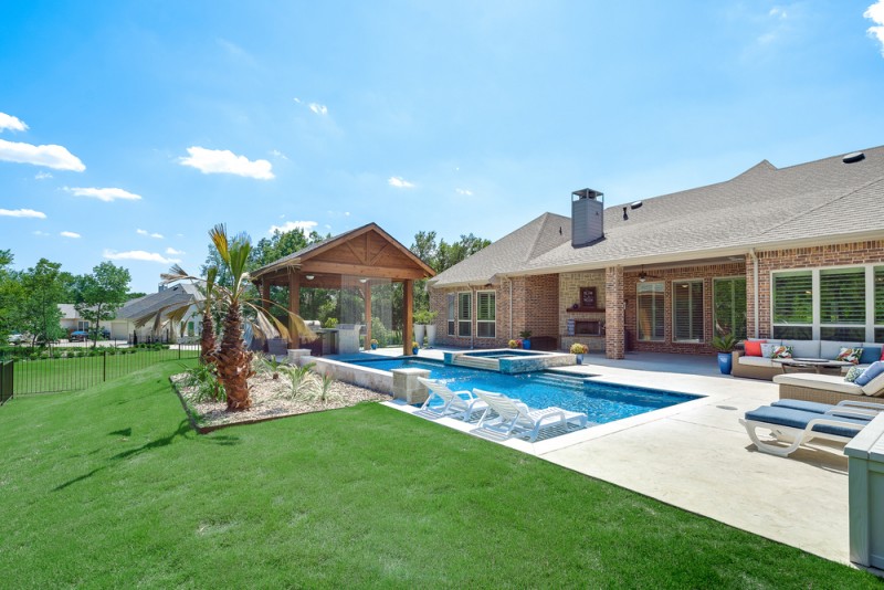    Extended Stamped Concrete Patio wraps around the Sparkling Swimming Pool 