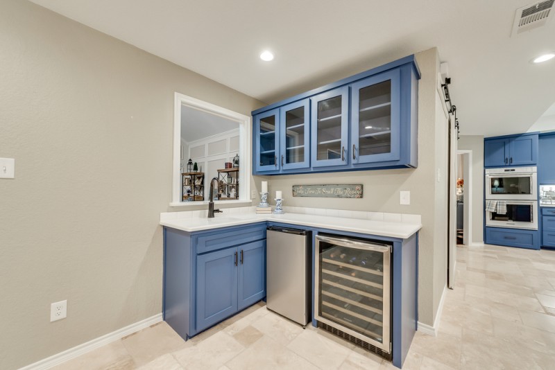    Stunning Wet Bar with Wine Fridge and Glass Accented Cabinetry 