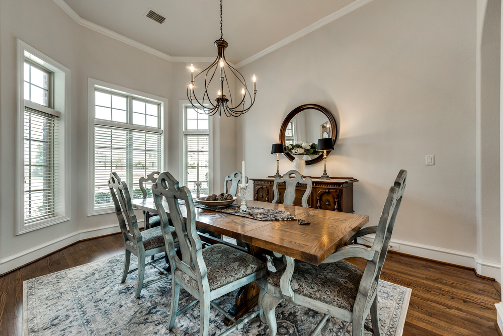    Elegant Formal Dining Room features Chic Chandelier and Bay Window 