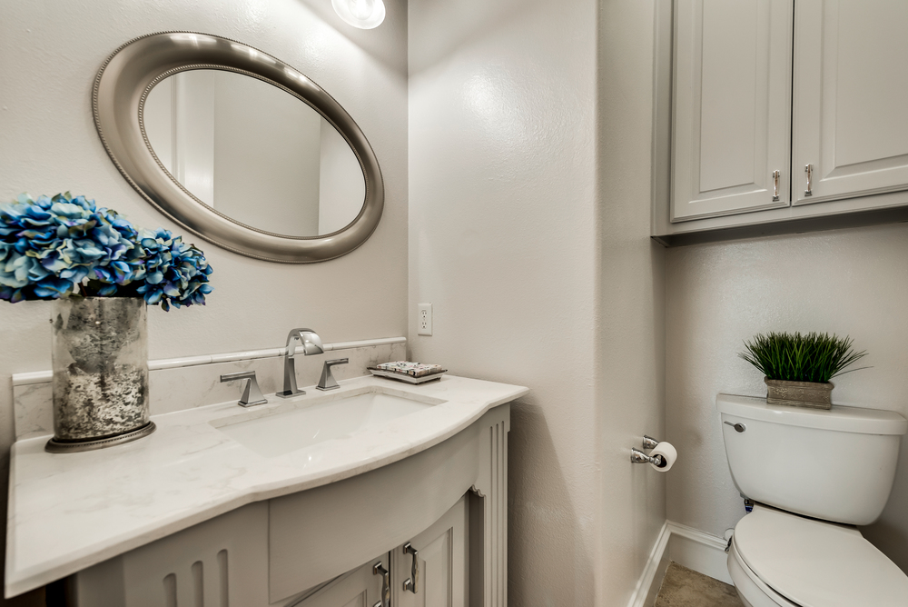    Half Bath for Guests with Furniture Style Vanity and Framed Mirror 