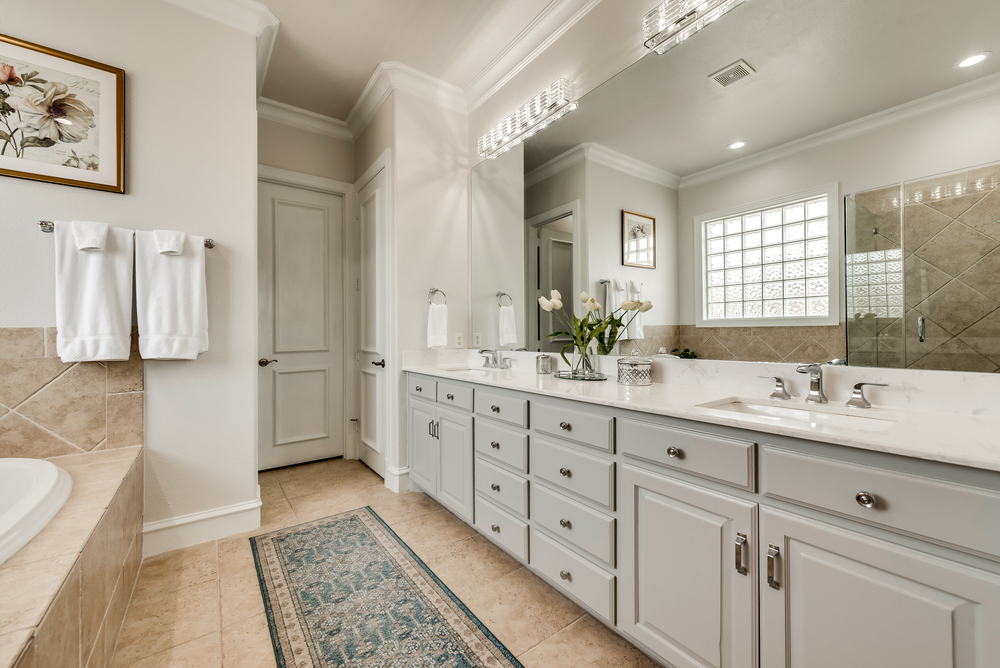    Spa Like Master Bath features Quartz Countertops Sleek Lighting and Custom Walk In Closet 