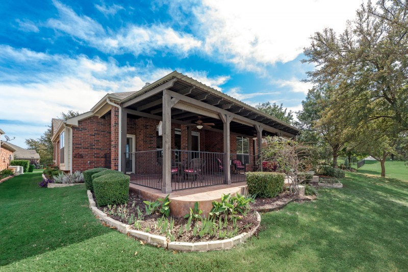    Patio Surround by Wrought Iron Fencing and Landscaping 