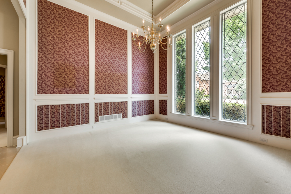    Elegant Formal Dining features Extensive Molding and Stunning Wall of Wrought Iron Detailed Windows 