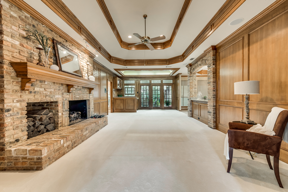    Inviting Family Room features Wood Paneled Walls Brick Gas Log Fireplace and Wet Bar 