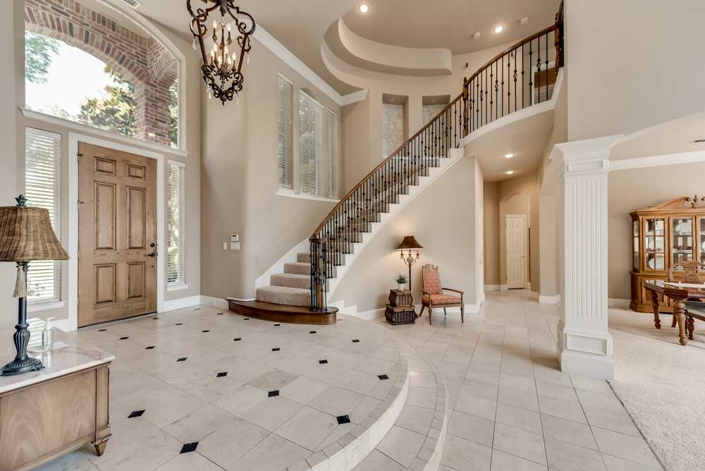    Entry has Soaring Ceilings and Grand Sweeping Staircase 