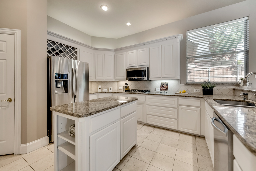    Gourmet Kitchen features Granite Countertops and White Cabinetry 