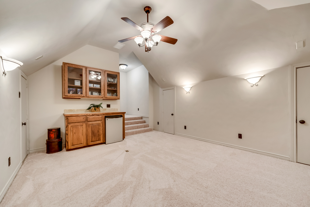    Media Room with Sconce Lighting Built In Cabinetry Room for Mini Fridge and Abundance of Storage 