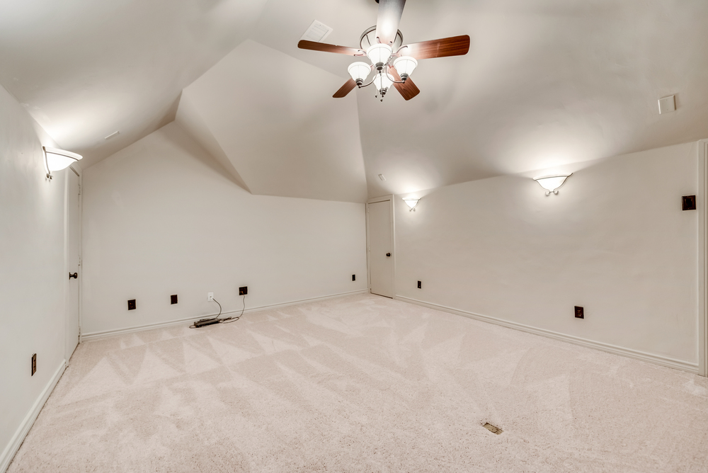    Media Room with Sconce Lighting Built In Cabinetry Room for Mini Fridge and Abundance of Storage 
