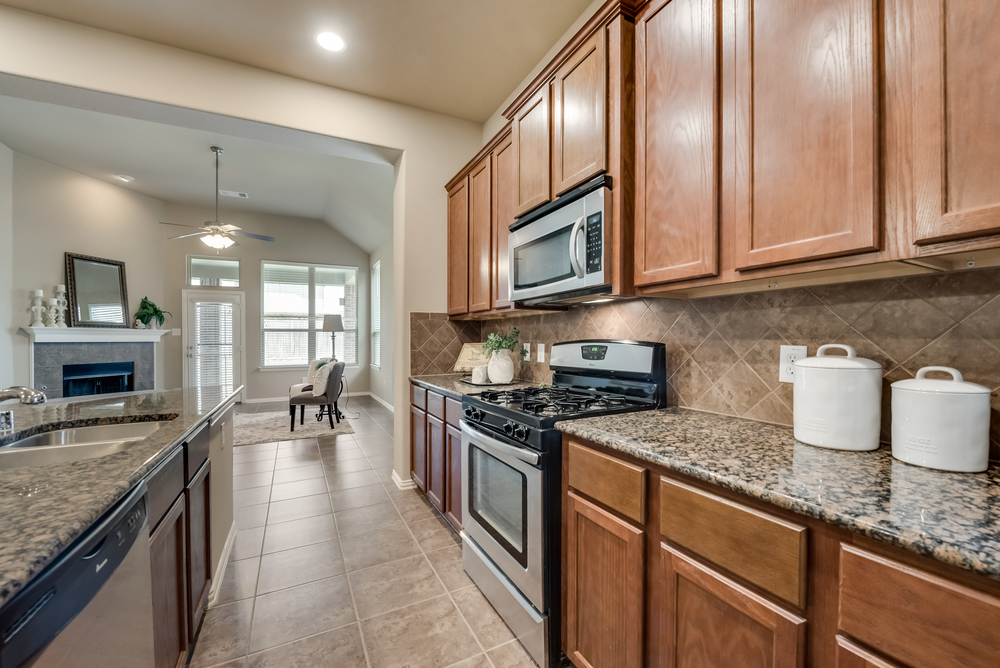    Chef s Kitchen with Tile Backsplash and Stainless Steel Appliances 