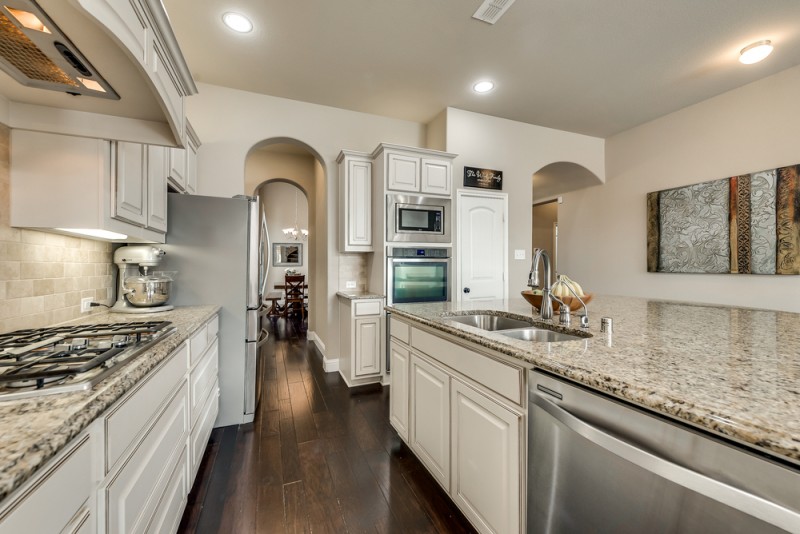    Gourmet Kitchen with Granite Counters and Antique Cabinetry 