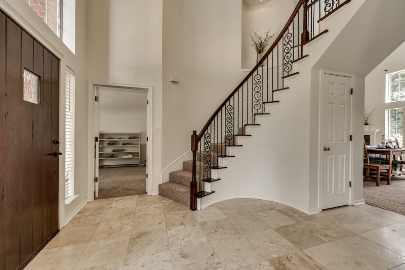    Entry with Beautiful Wrought Iron Staircase and Soaring Ceilings 