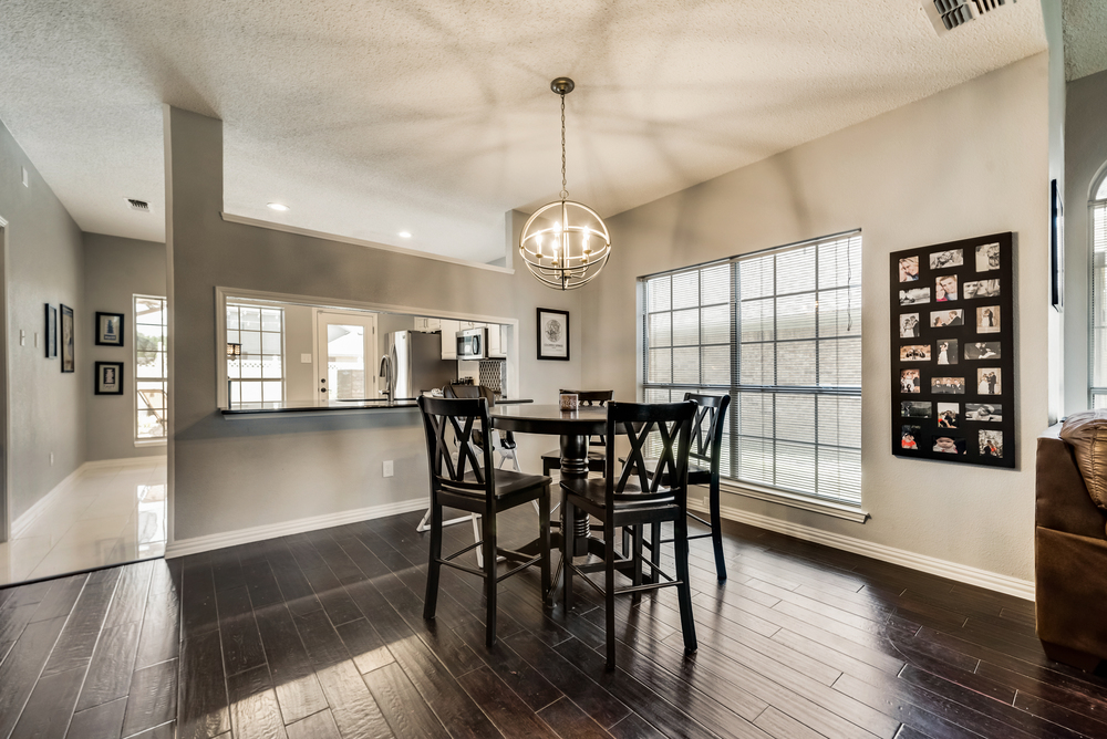    Dining Area with Chic Light Fixture and Built In Cabinetry   
