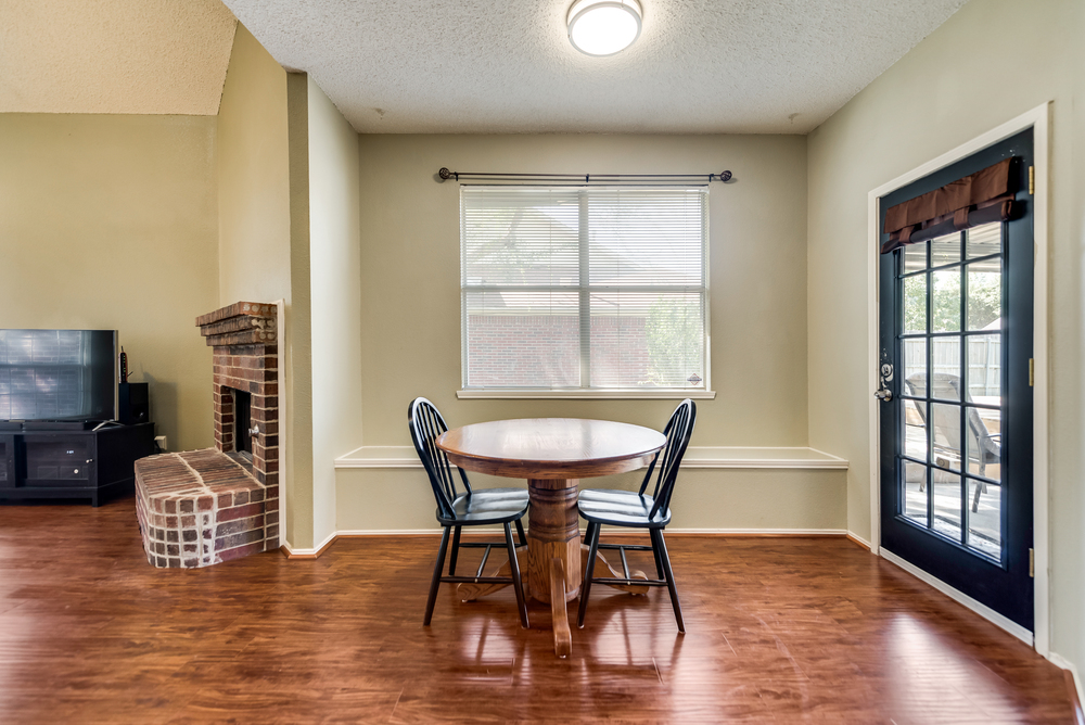    Charming Dining Area with Window Seat and Door to Patio 
