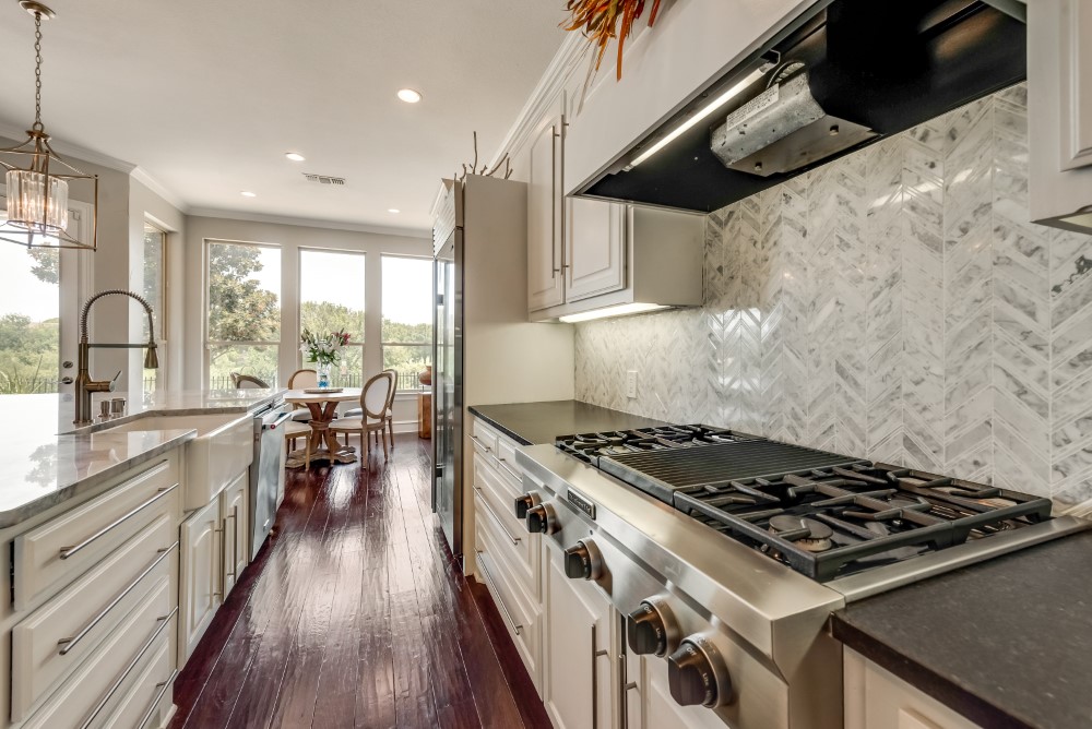    Honed Granite Counters and Kitchenaid Gas Cooktop 