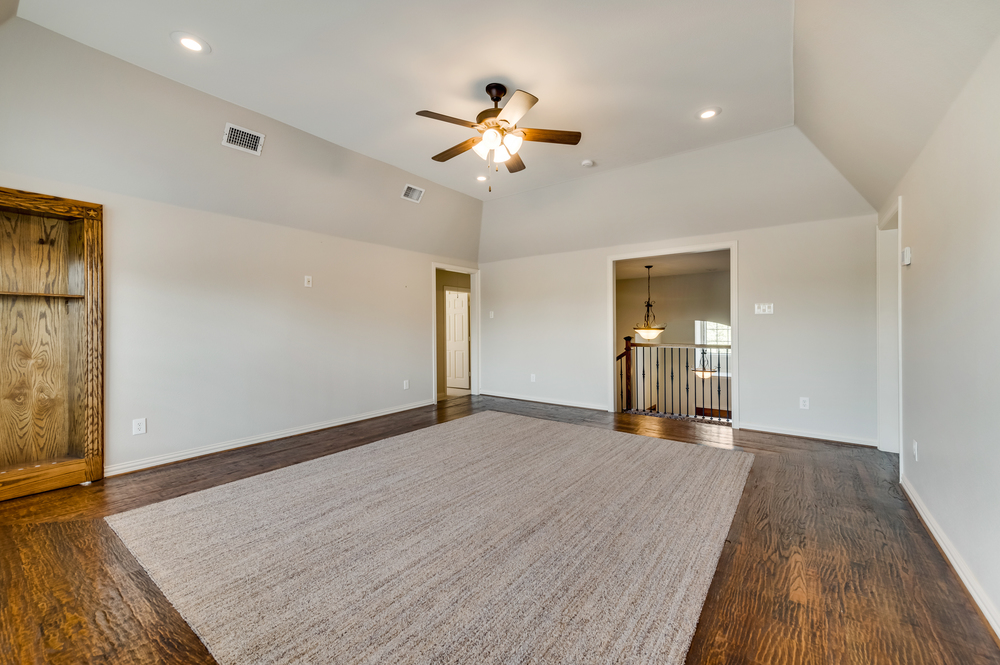    Upstairs Game Room has Hand Scraped Hardwood Floor Walkways and Built In Shelving Unit 