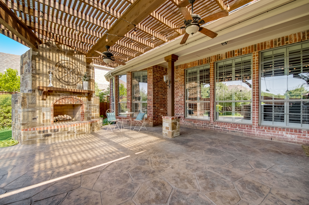    Pergola Covered Stamped Concrete Patio and Stone Gas Log Fireplace 